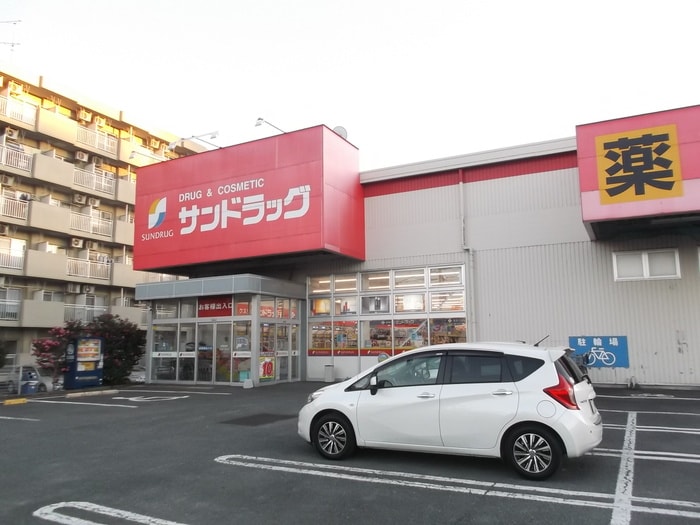 サンドラッグ(ドラッグストア)まで15m アトラクトマンショントムロ