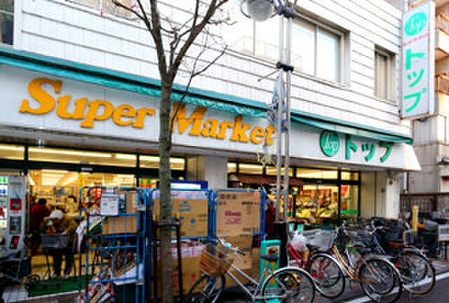 トップ小田店(スーパー)まで507m リブリ・美ら島ガーデン