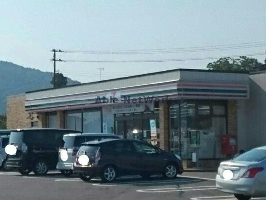 セブンイレブン小千谷大橋店(コンビニ)まで1055m ユーソニアン・三仏生A